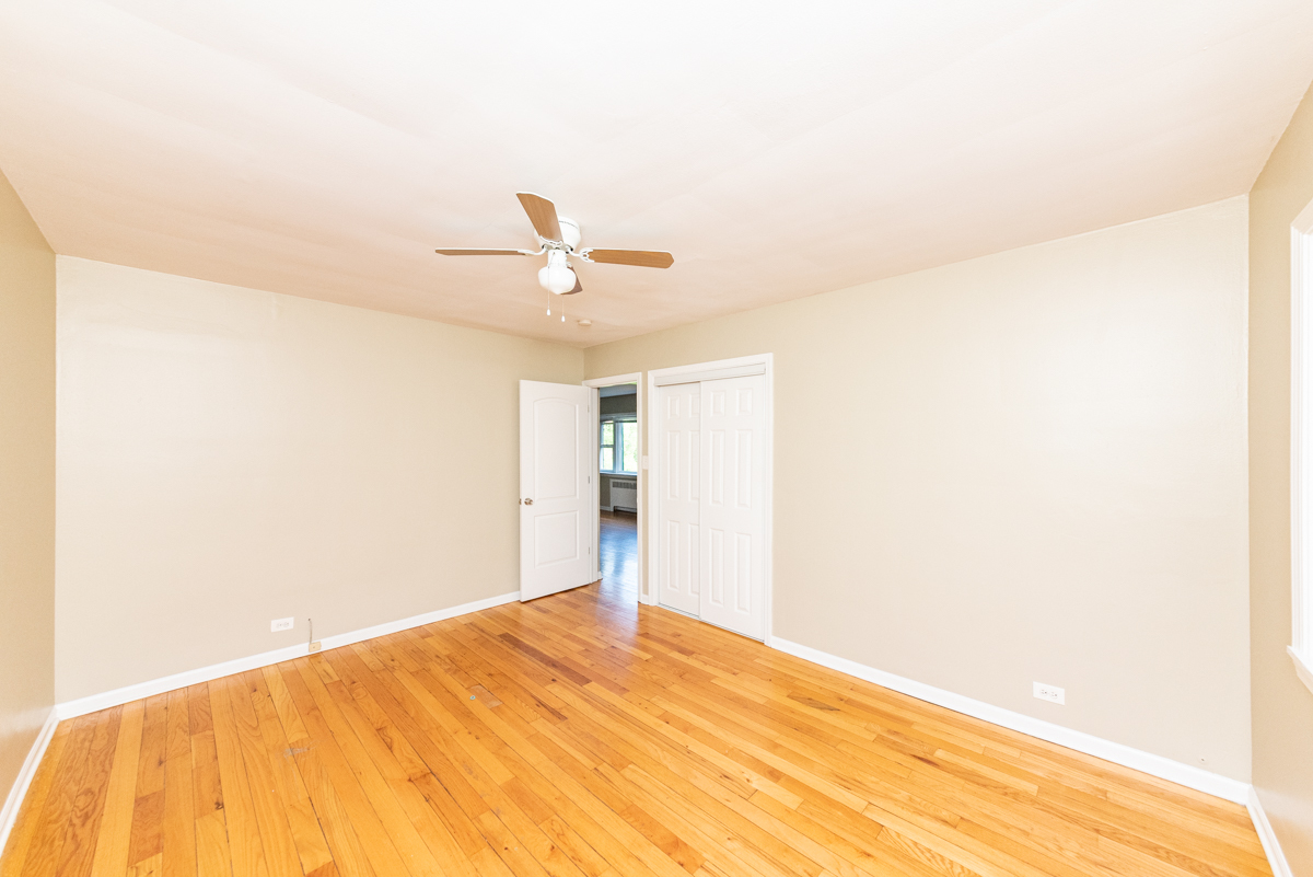 225 Custer Avenue, Unit 3 Evanston, IL 60202 - Photo 9 of 13 a view of a big room with closet and ceiling fan