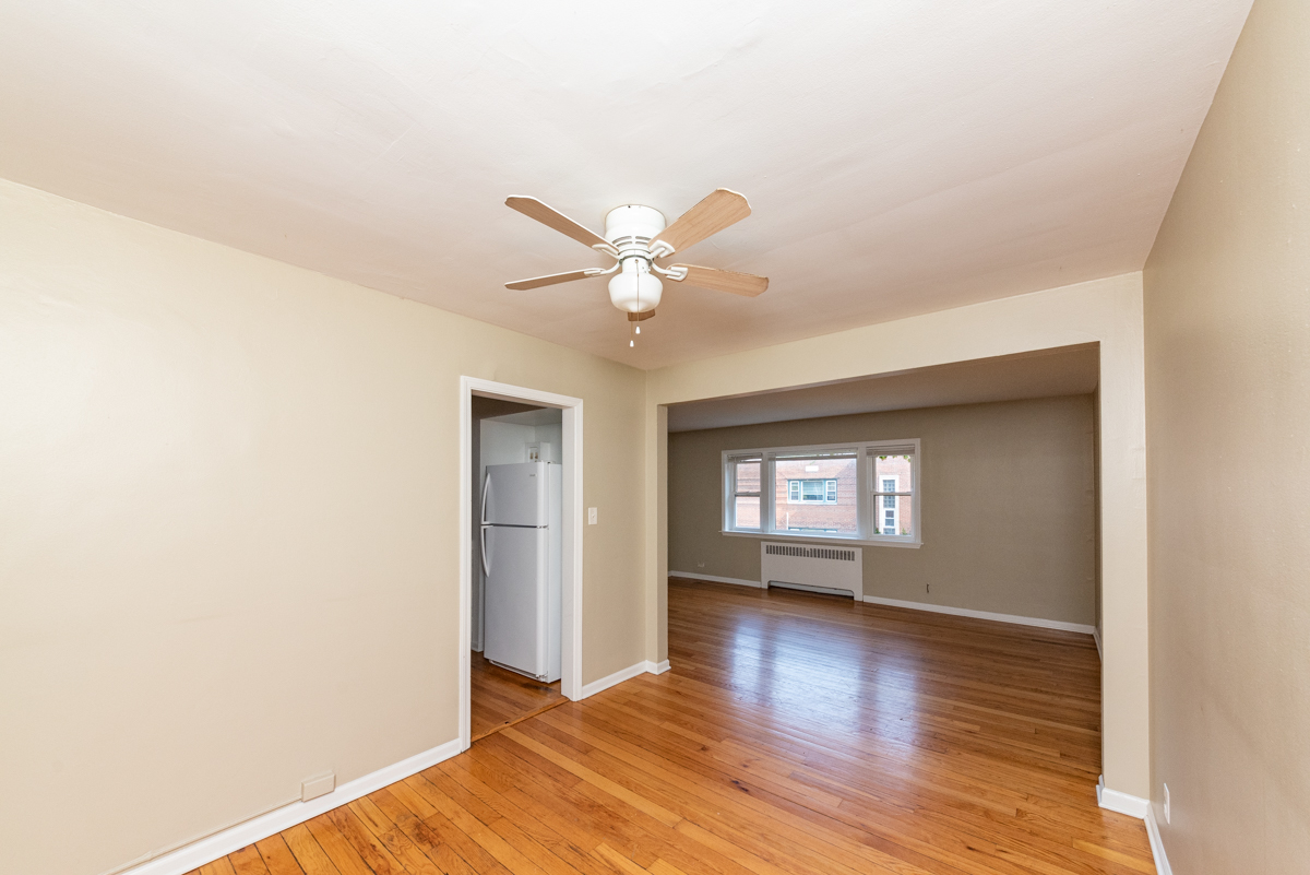 225 Custer Avenue, Unit 3 Evanston, IL 60202 - Photo 10 of 13 a view of wooden floor and a chandelier fan in a room