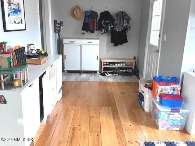 a view of entryway and hall with wooden floor