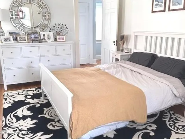 a bedroom with a bed and a window in it