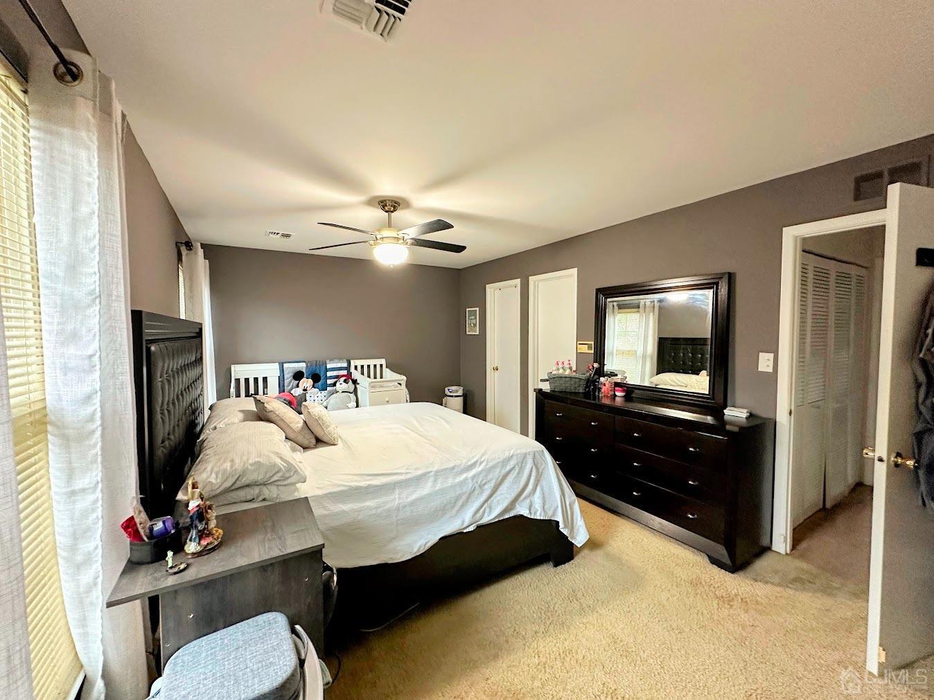 60 County Road, Unit 33F Cliffwood, NJ 07721 - Photo 11 of 13 a bedroom with a bed and dresser with mirror