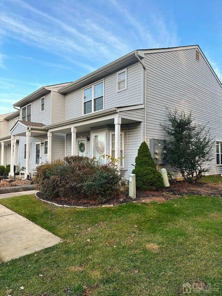 60 County Road, Unit 33F Cliffwood, NJ 07721 - Photo 2 of 13 a view of a white house next to a yard with plants and trees