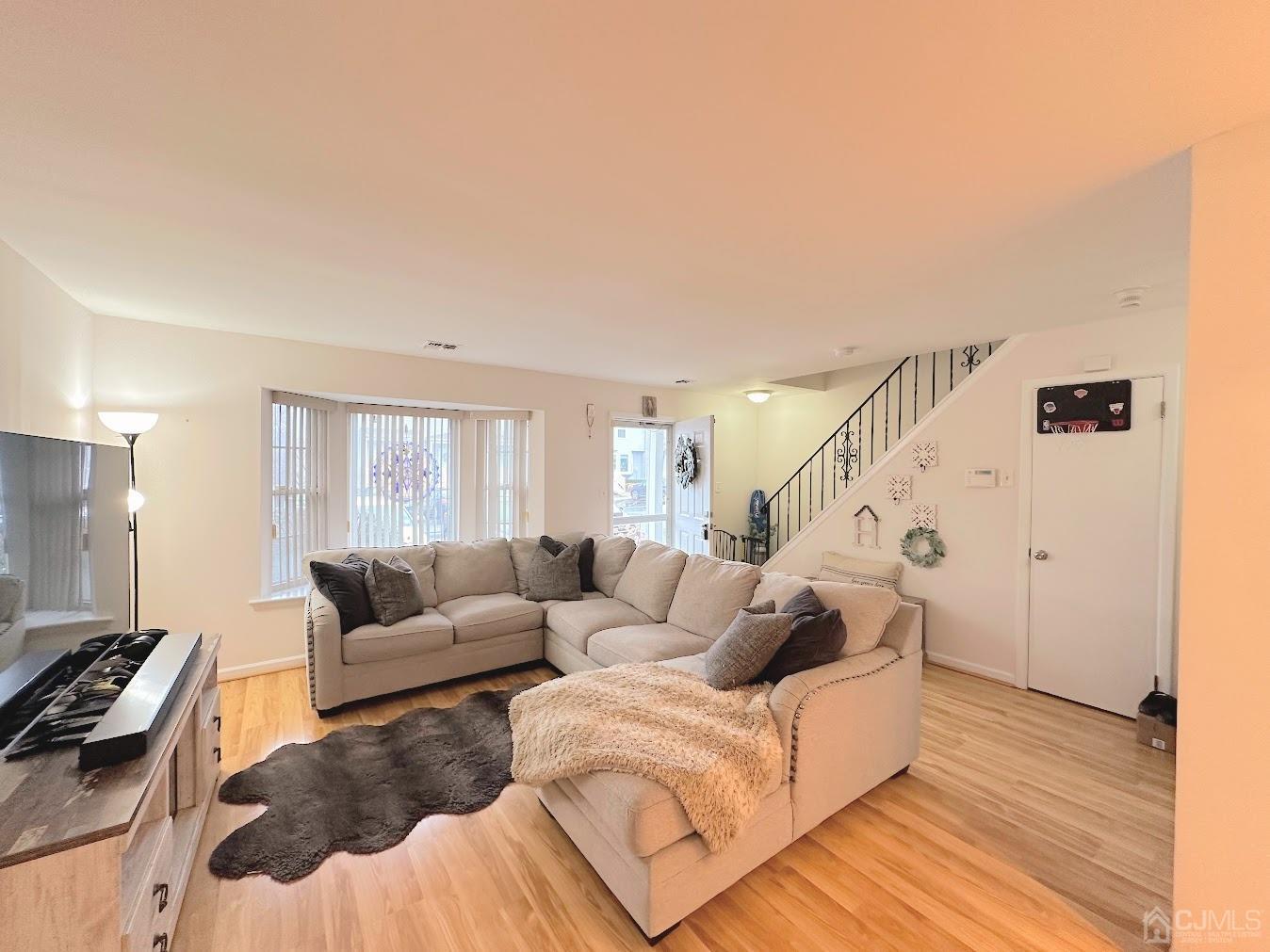 60 County Road, Unit 33F Cliffwood, NJ 07721 - Photo 3 of 13 a living room with furniture and a flat screen tv