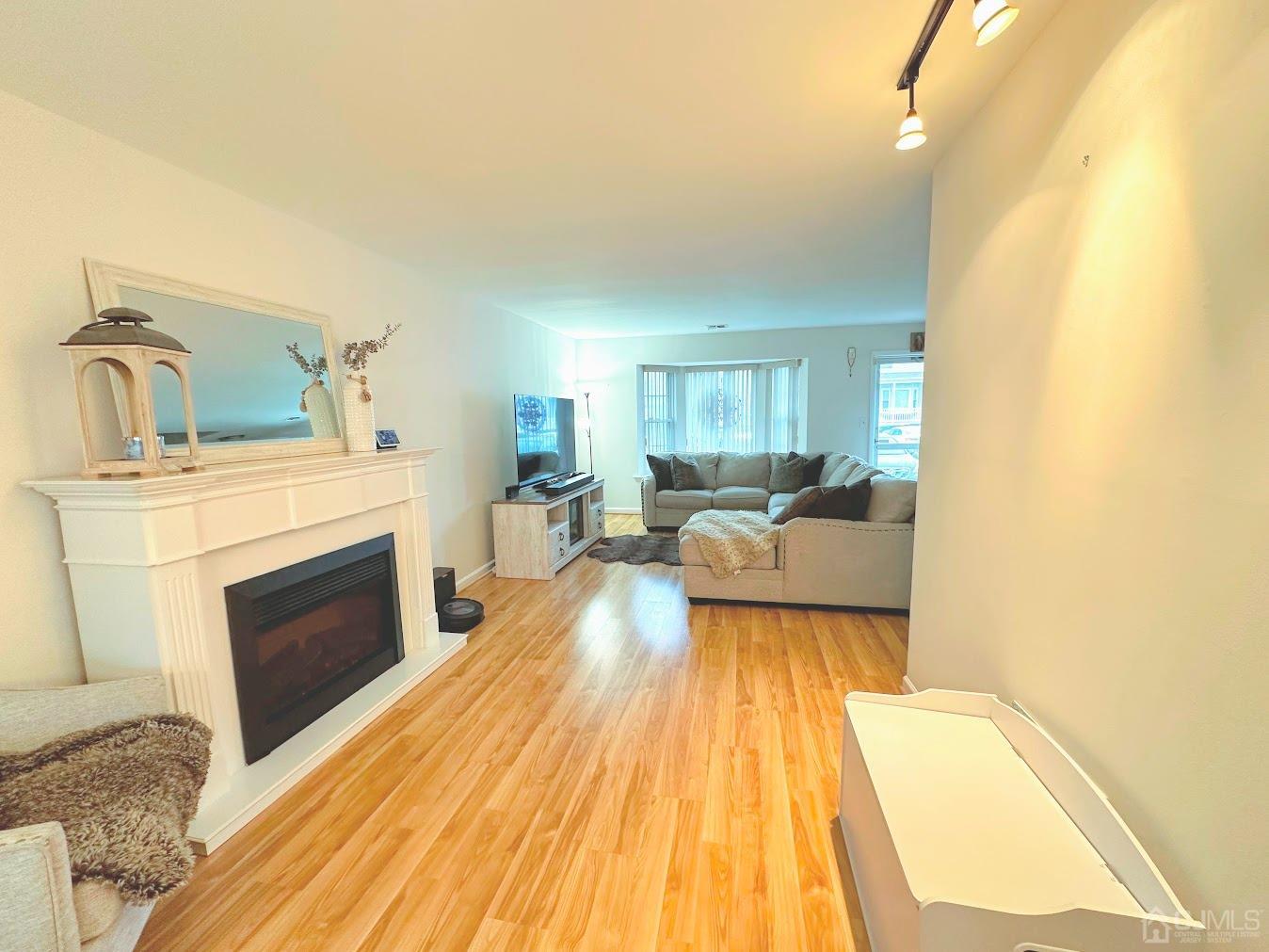 60 County Road, Unit 33F Cliffwood, NJ 07721 - Photo 4 of 13 a living room with furniture and a fireplace