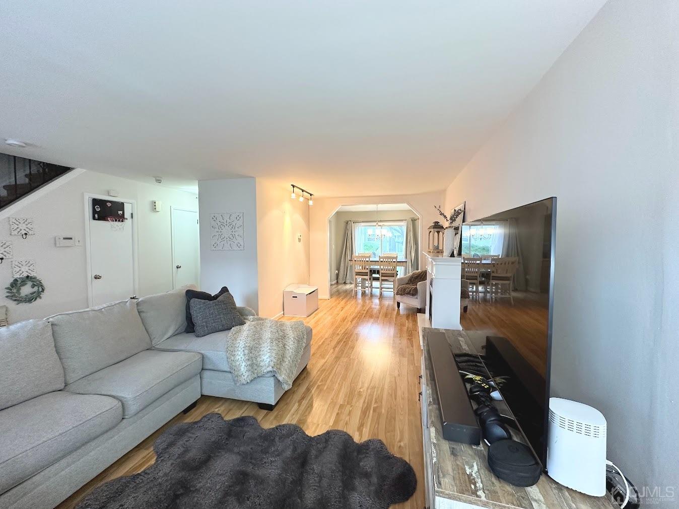 60 County Road, Unit 33F Cliffwood, NJ 07721 - Photo 5 of 13 a living room with furniture and a flat screen tv