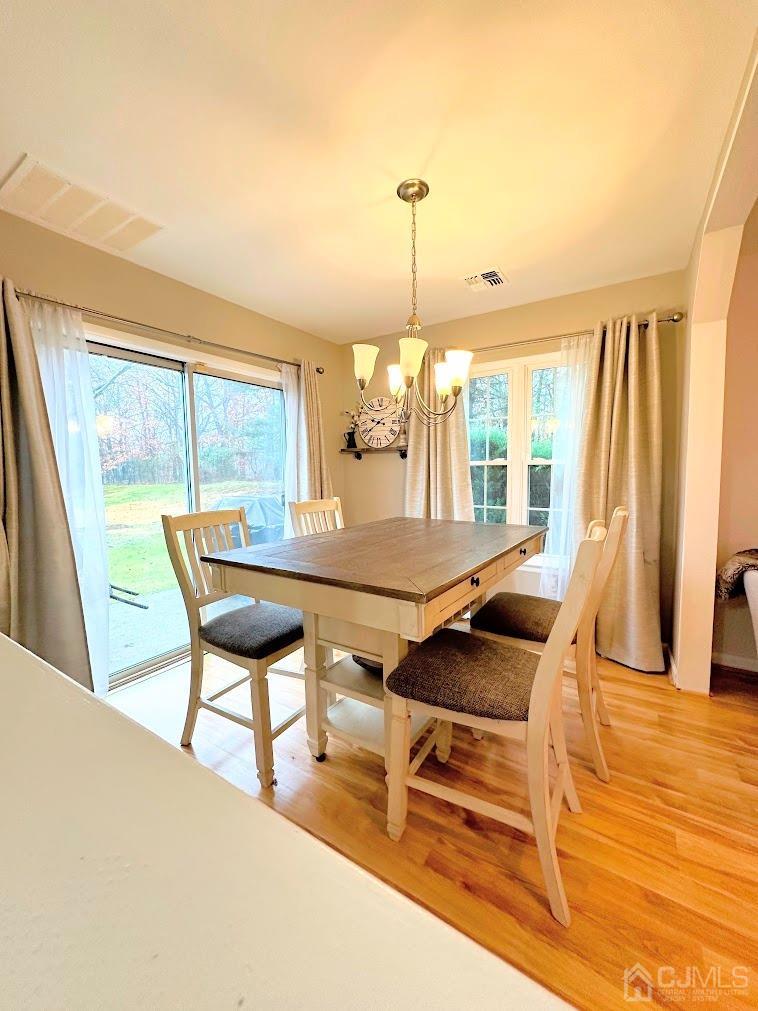 60 County Road, Unit 33F Cliffwood, NJ 07721 - Photo 6 of 13 a view of a dining room with furniture and wooden floor