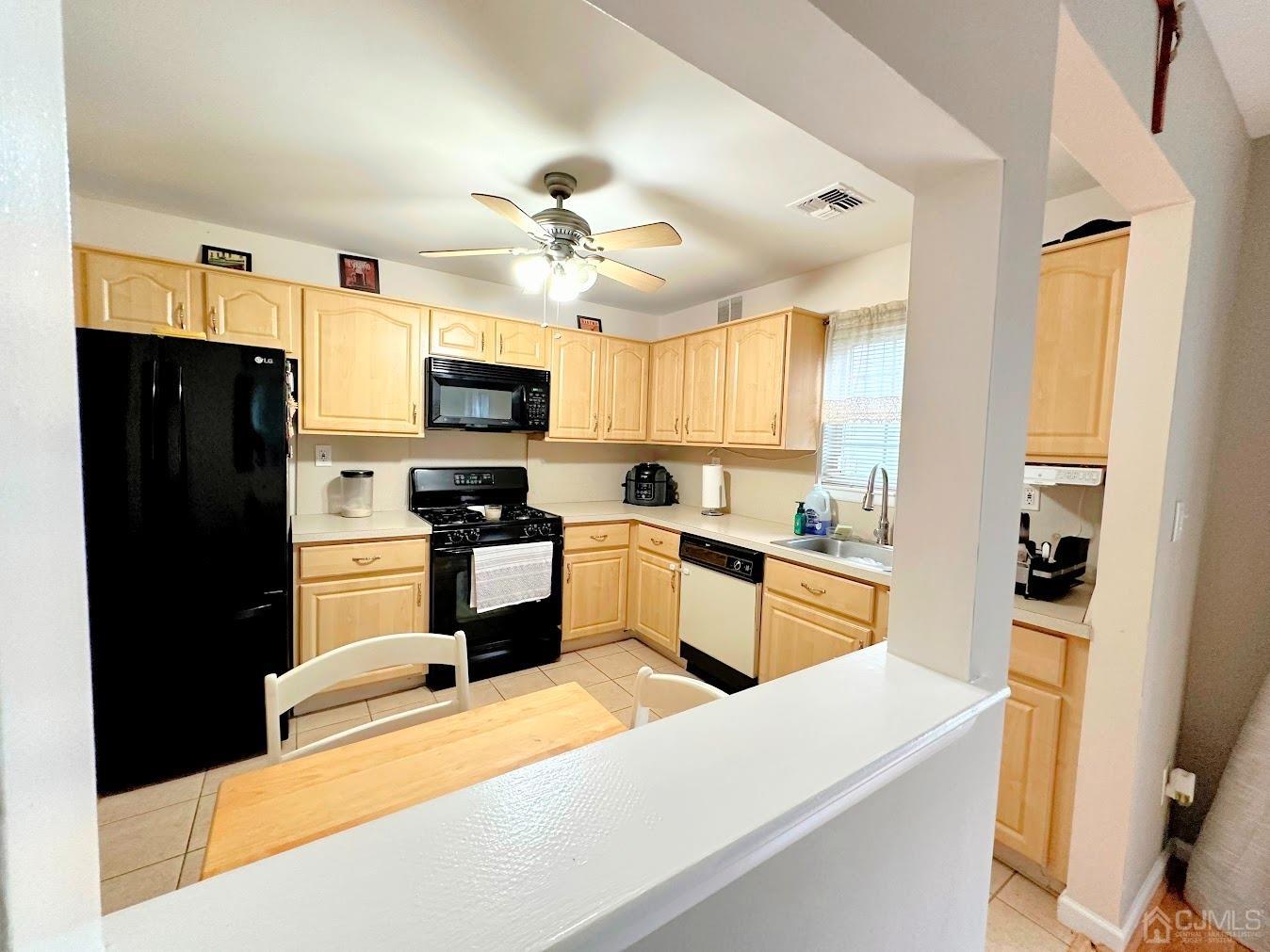 60 County Road, Unit 33F Cliffwood, NJ 07721 - Photo 7 of 13 a kitchen with stainless steel appliances granite countertop a refrigerator stove microwave and sink