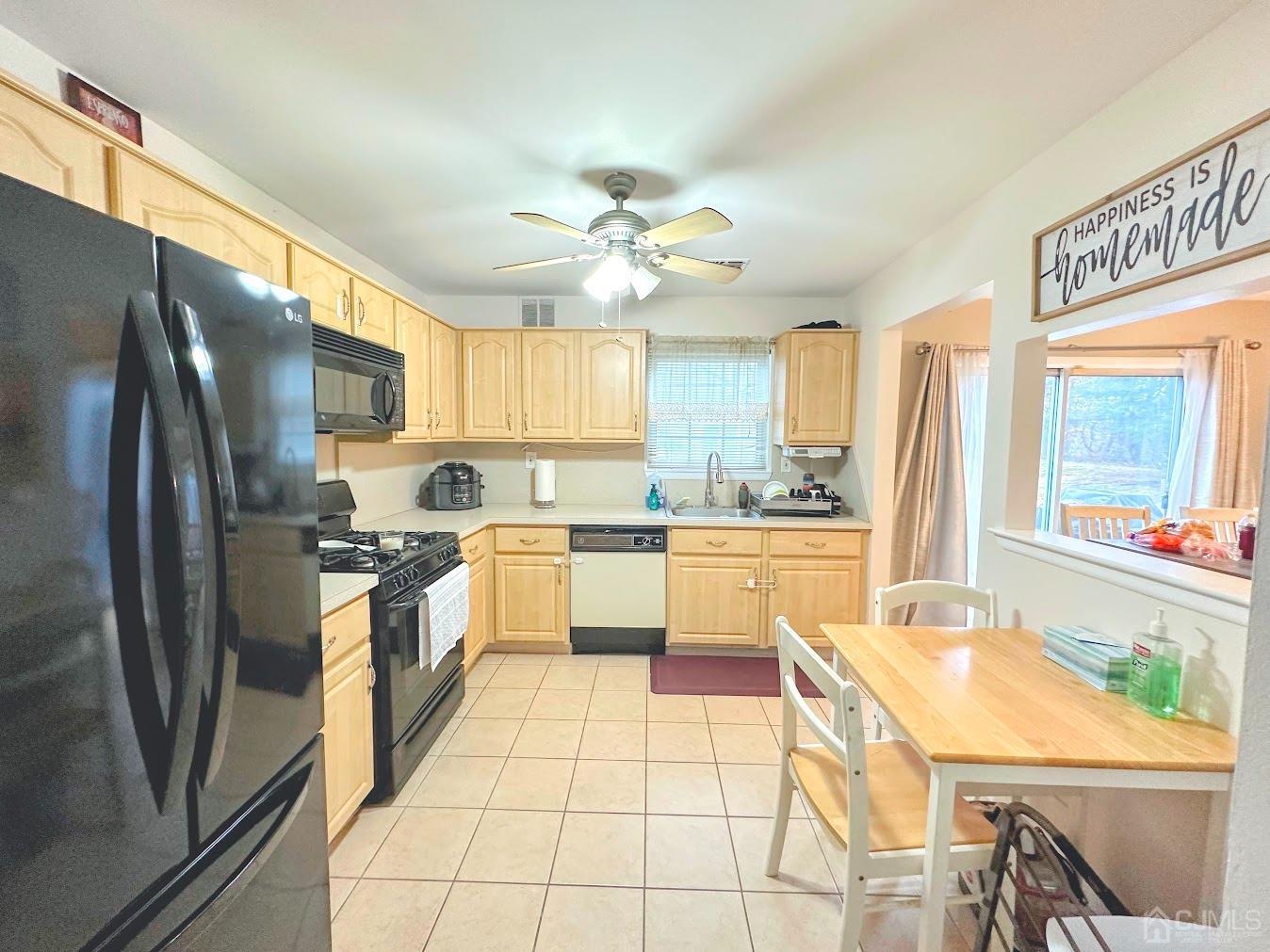 60 County Road, Unit 33F Cliffwood, NJ 07721 - Photo 8 of 13 a large kitchen with stainless steel appliances kitchen island granite countertop a refrigerator a sink a stove and island