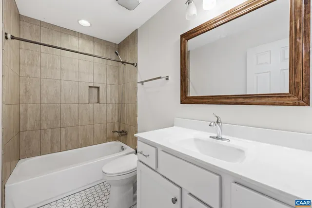 an empty room with wooden floor and fan