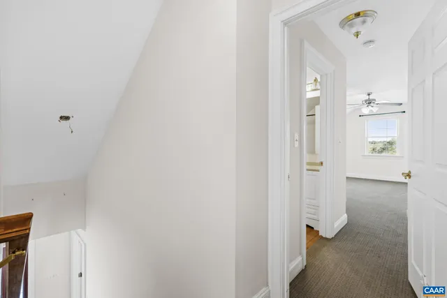 en empty room with windows and ceiling fan