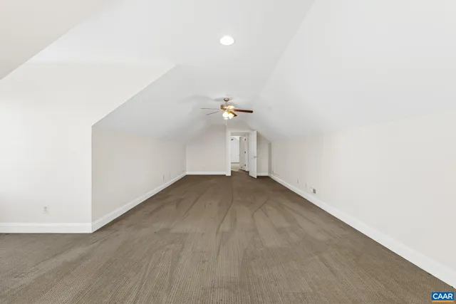 an empty room with a window and a ceiling fan