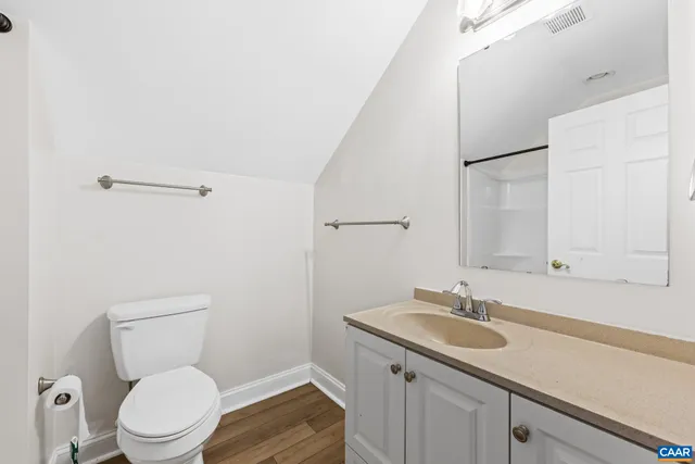 a view of deck with wooden floor and fence with a bench