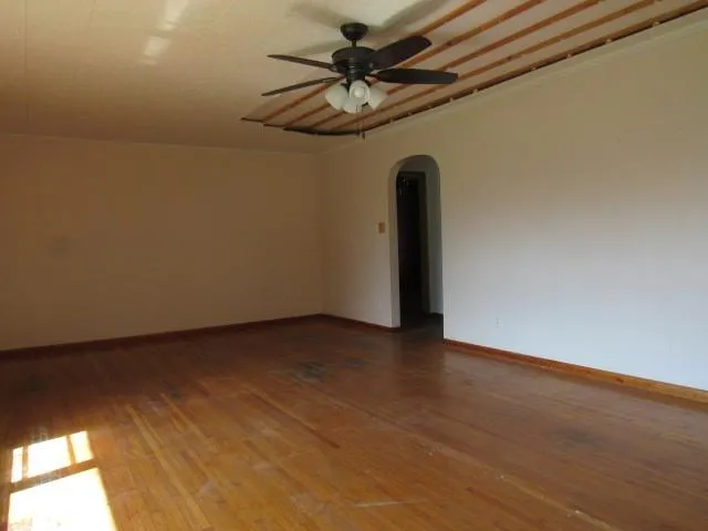a view of a livingroom with a ceiling fan and window