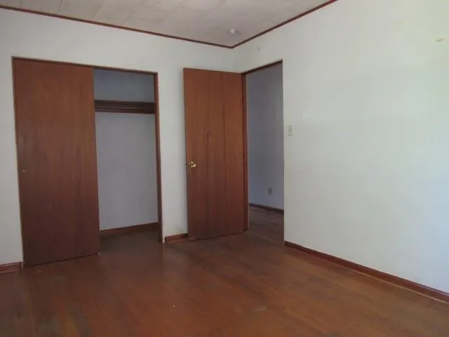 an empty room with closet area