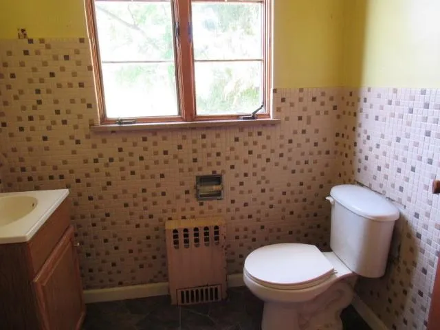 a bathroom with a toilet and a sink