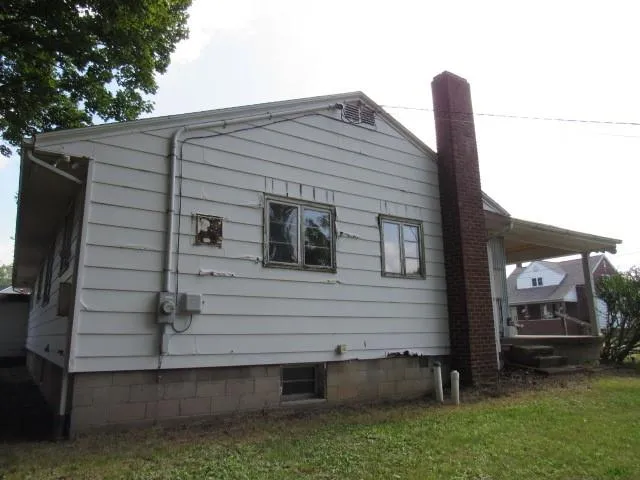 a view of house with backyard