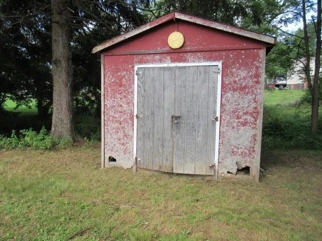 a sign that is in front of a brick house