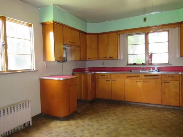 a room with window and cabinet