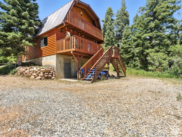 1180 Oak Road Coalville, UT 84017 - Photo 1 of 25 Rear view of house with a gambrel roof, stairway, a metal roof, and a wooden deck