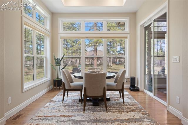778 Cumberland Road Larkspur, CO 80118 - Photo 9 of 31 Kitchen eat-in surrounded by windows and accesses patio