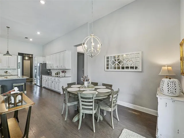 a living room with furniture a fireplace and a large window