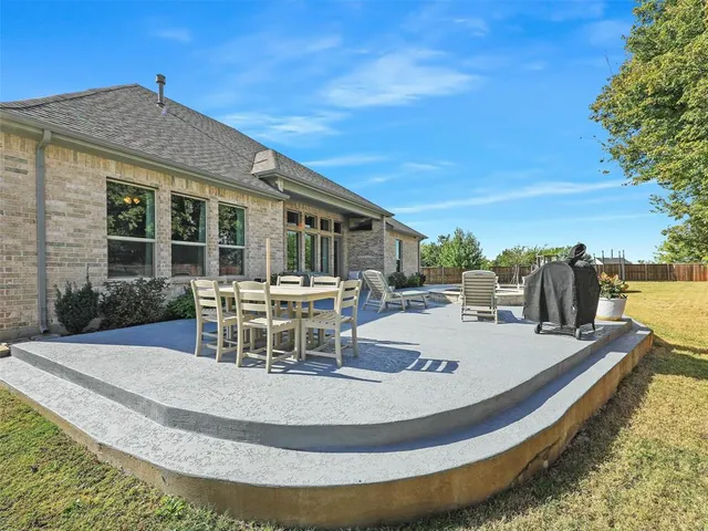 a view of a house with swimming pool and sitting area