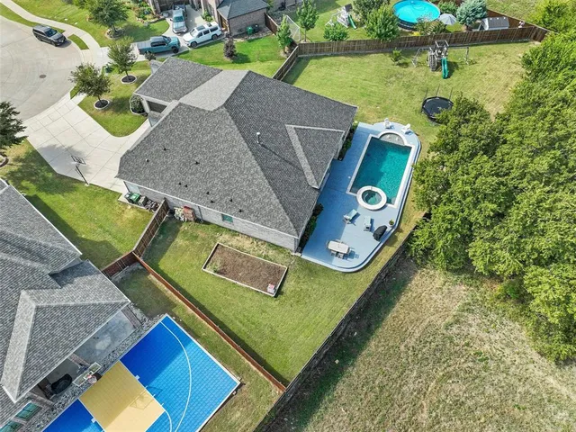 a view of a house with pool and chairs