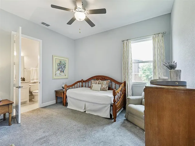 a living room with a bed furniture and a window