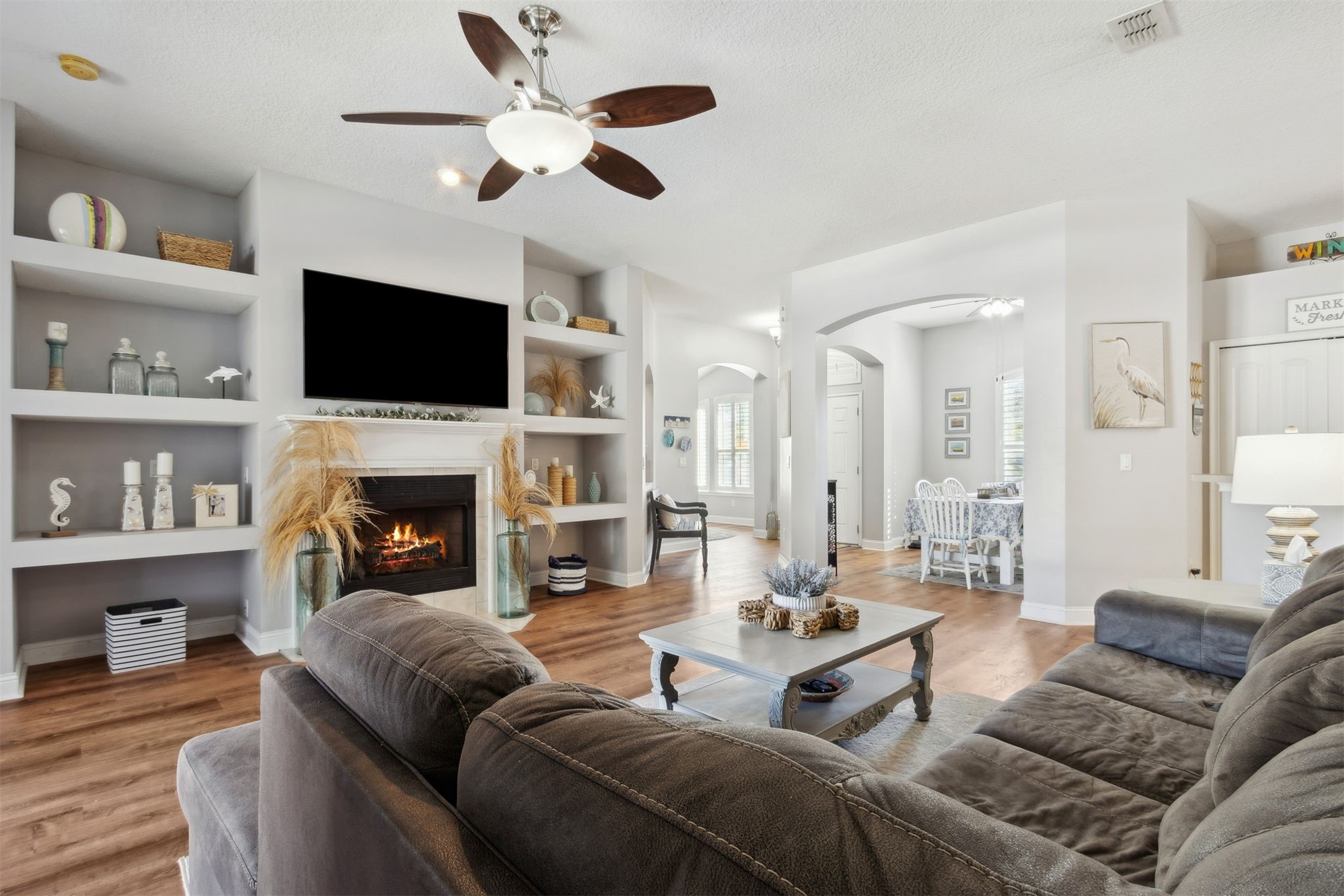 86027 Maple Leaf Place Yulee, FL 32097 - Photo 11 of 38 a living room with furniture fireplace and a flat screen tv