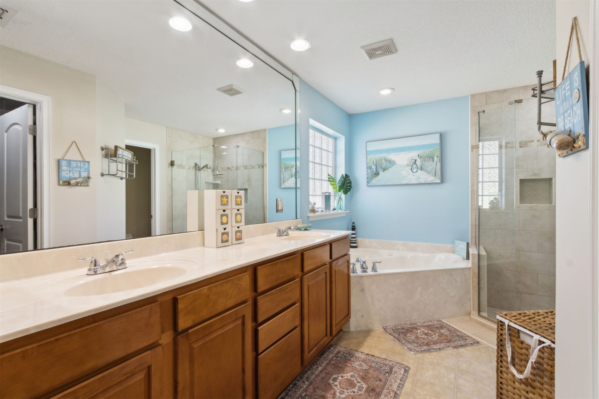 86027 Maple Leaf Place Yulee, FL 32097 - Photo 22 of 38 a bathroom with a sink double vanity granite tub shower and a mirror