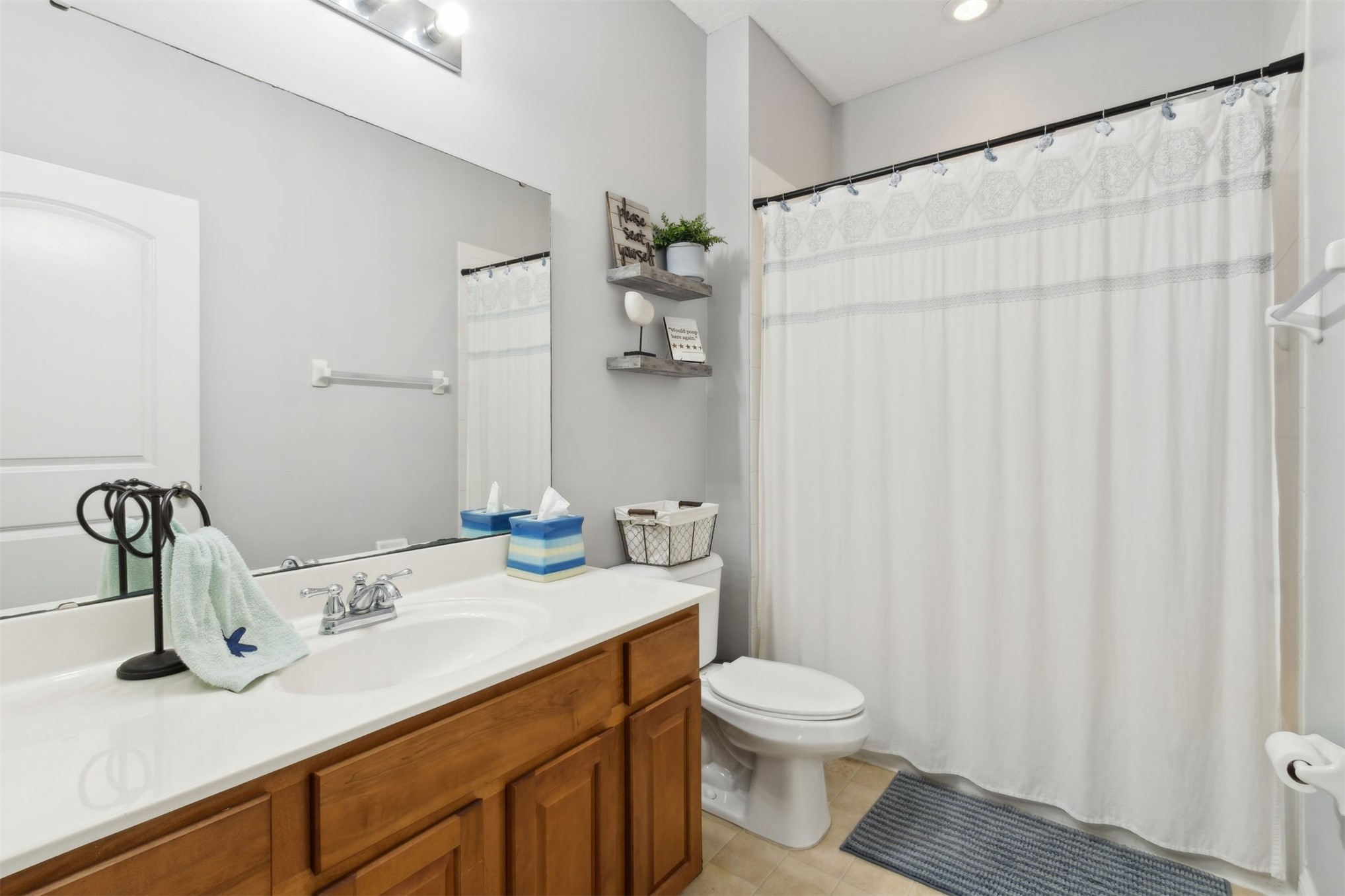 86027 Maple Leaf Place Yulee, FL 32097 - Photo 30 of 38 a bathroom with a granite countertop sink a toilet and a mirror