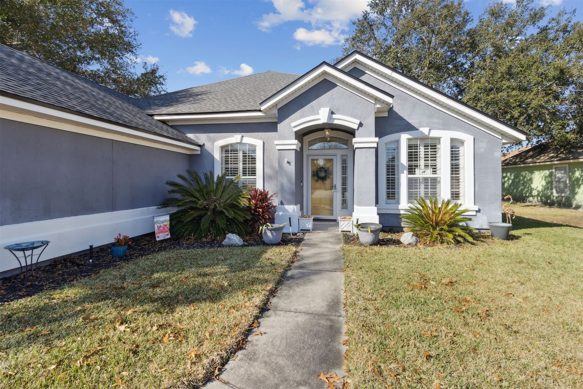86027 Maple Leaf Place Yulee, FL 32097 - Photo 4 of 38 a front view of a house with a yard