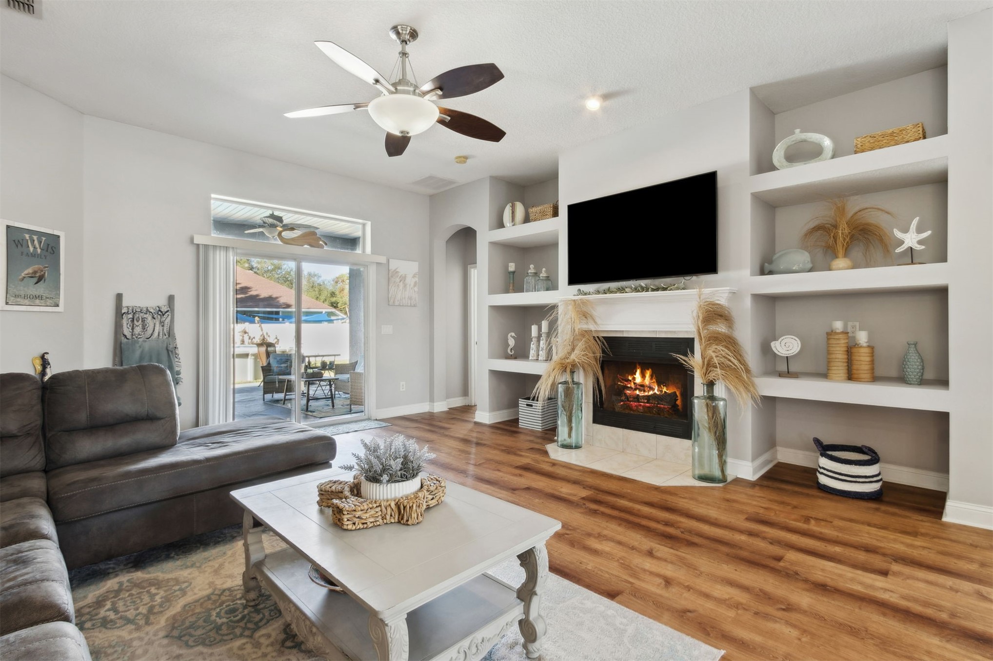 86027 Maple Leaf Place Yulee, FL 32097 - Photo 9 of 38 a living room with furniture a flat screen tv and a fireplace