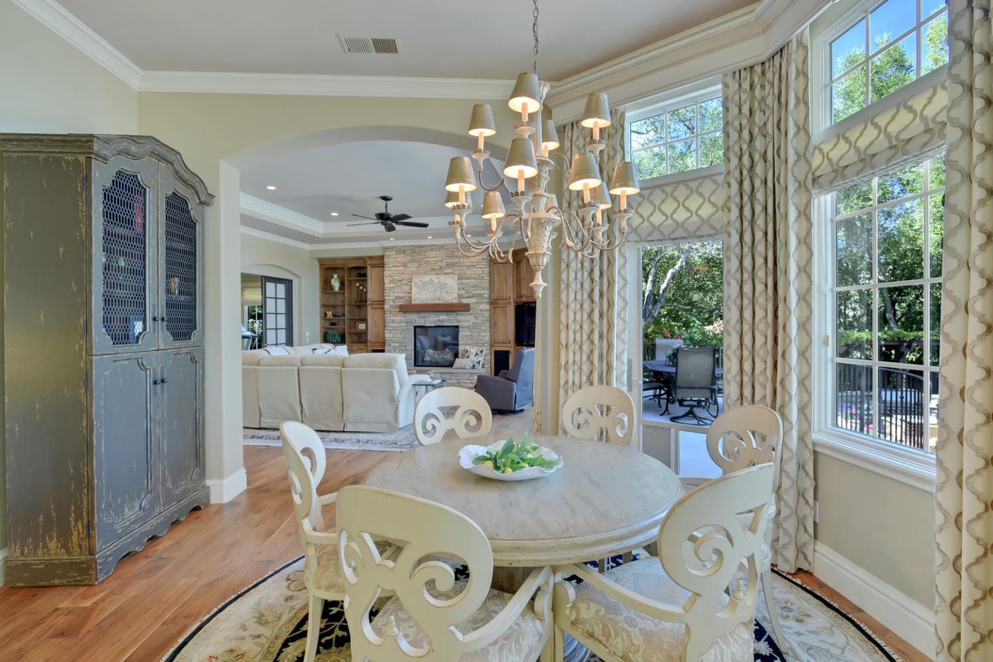 18485 Withey Road Monte Sereno, CA 95030 - Photo 13 of 39 a view of a dining room with furniture a chandelier and wooden floor