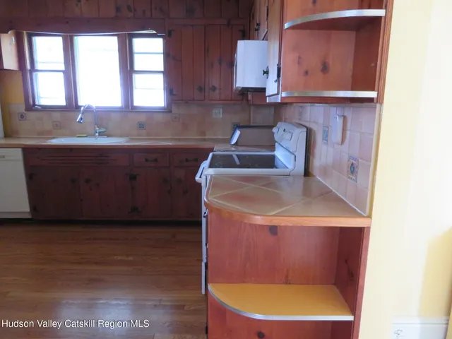 a kitchen with a sink a window and cabinets