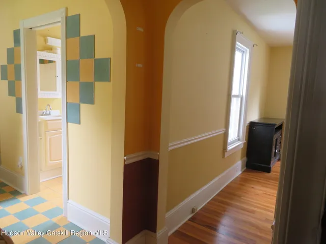 a bathroom with a sink toilet and window