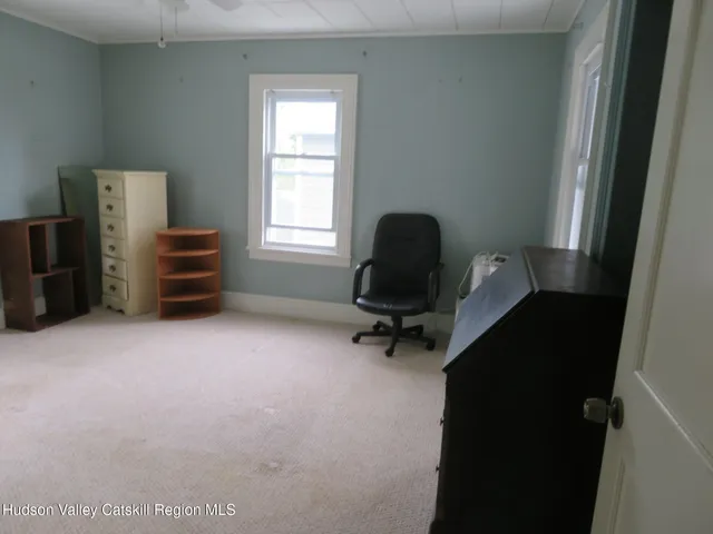 a view of room with window and furniture