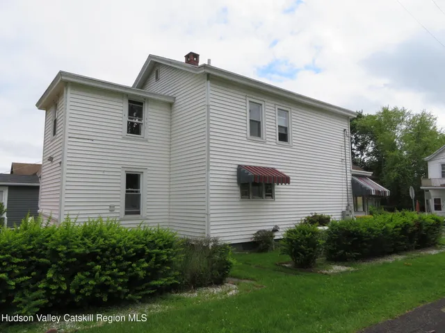 a view of house with a yard
