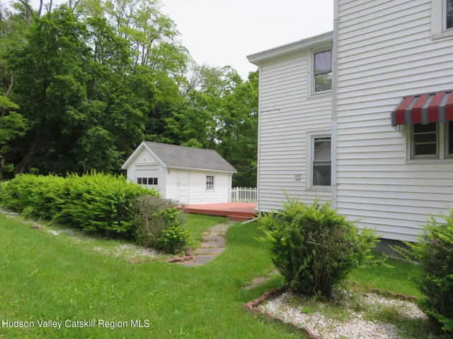 a front view of house with yard and outdoor seating