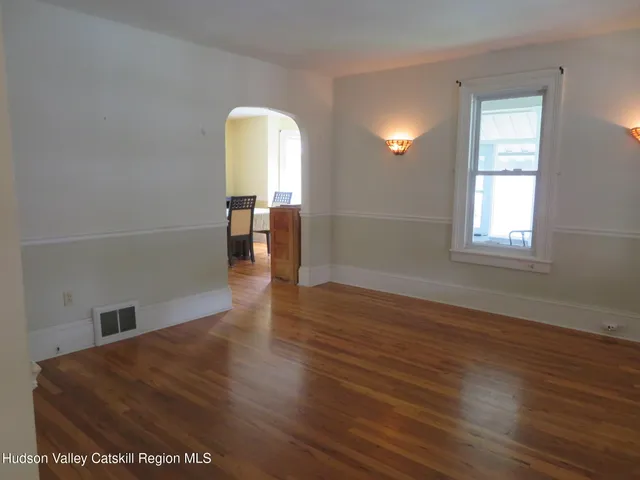a view of a room with wooden floor and a window