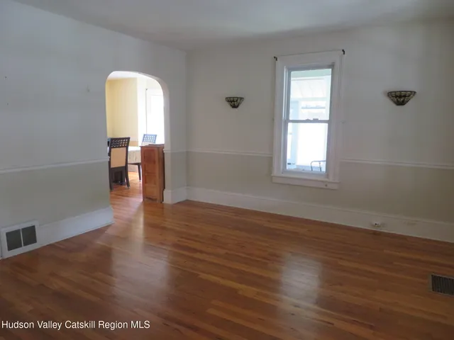 a view of a room with wooden floor and a window