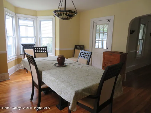 a view of a dining room with furniture window and wooden floor