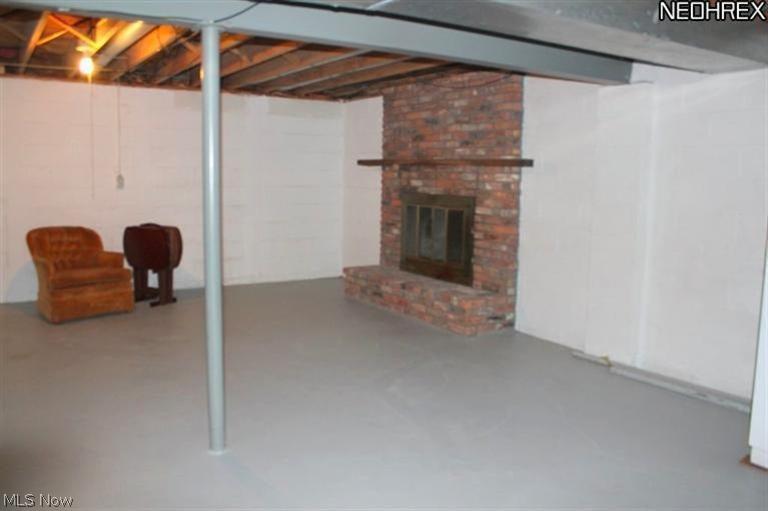 4231 Baird Road Stow, OH 44224 - Photo 22 of 23 The basement is clean, partially finished with a fireplace and 10x13 paneled office, and built in wood storage shelving.