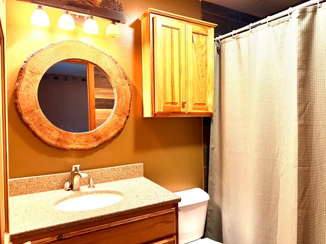 a bathroom with a glass door shower and a sink