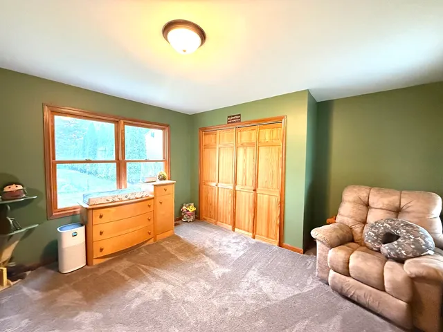 a bed room with a bed and a large window