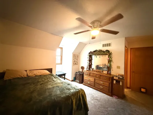 a bedroom with bed and a window