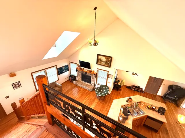 a living room with chairs and kitchen view
