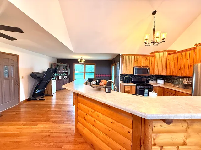 a kitchen with stainless steel appliances a refrigerator and a stove top oven