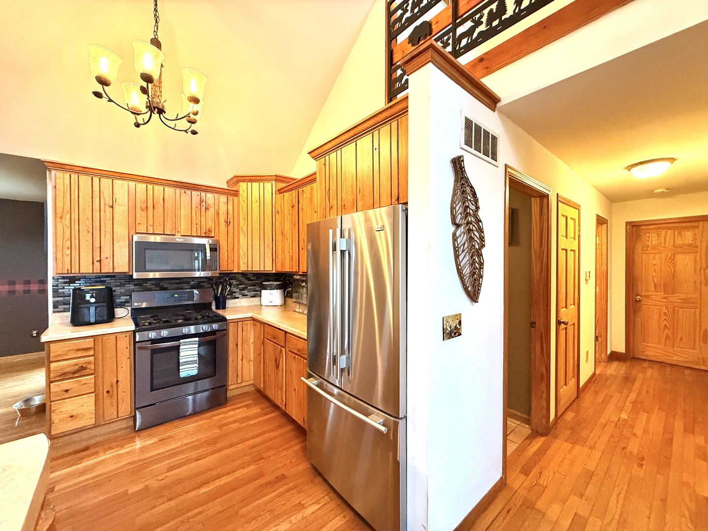 14944 South Steward Road Rochelle, IL 61068 - Photo 10 of 32 a kitchen with stainless steel appliances granite countertop a refrigerator a stove and a sink with wooden floor