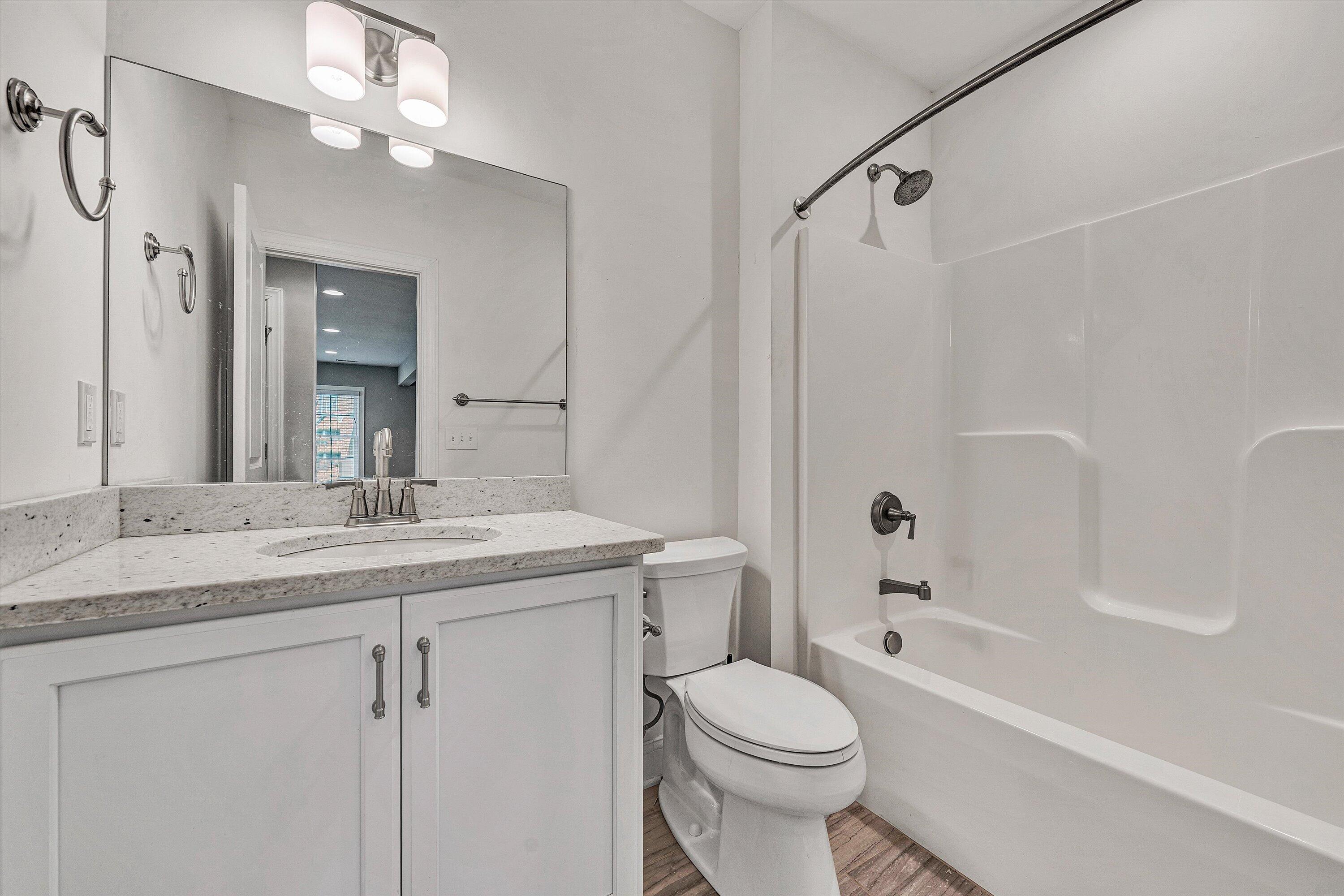 6981 Fairway Ridge Road Salem, VA 24153 - Photo 43 of 53 a bathroom with a granite countertop sink a toilet and shower